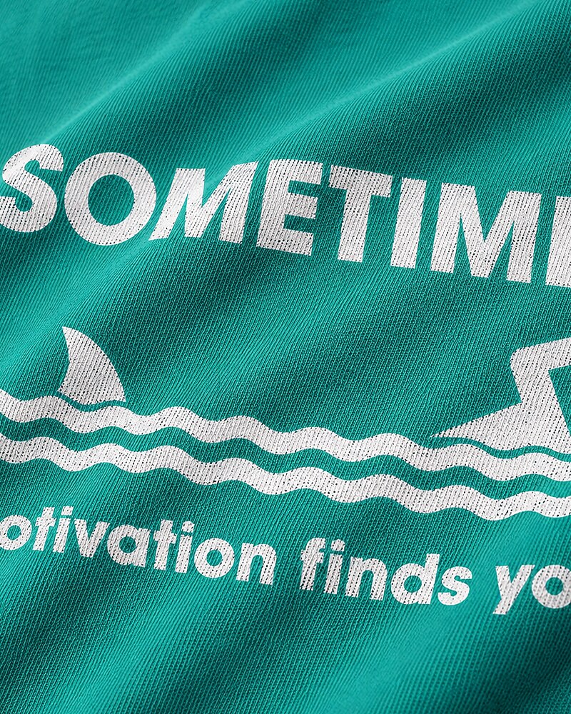 Sometimes Motivation Finds You swimming shark graphic on Nile Blue cotton T-shirt