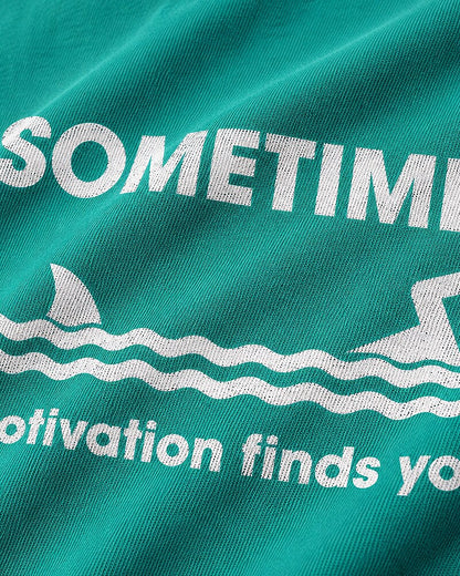 Sometimes Motivation Finds You swimming shark graphic on Nile Blue cotton T-shirt