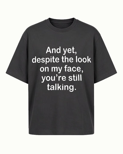 Despite the Look on My Face, You're Still Talking quote on Black cotton T-shirt