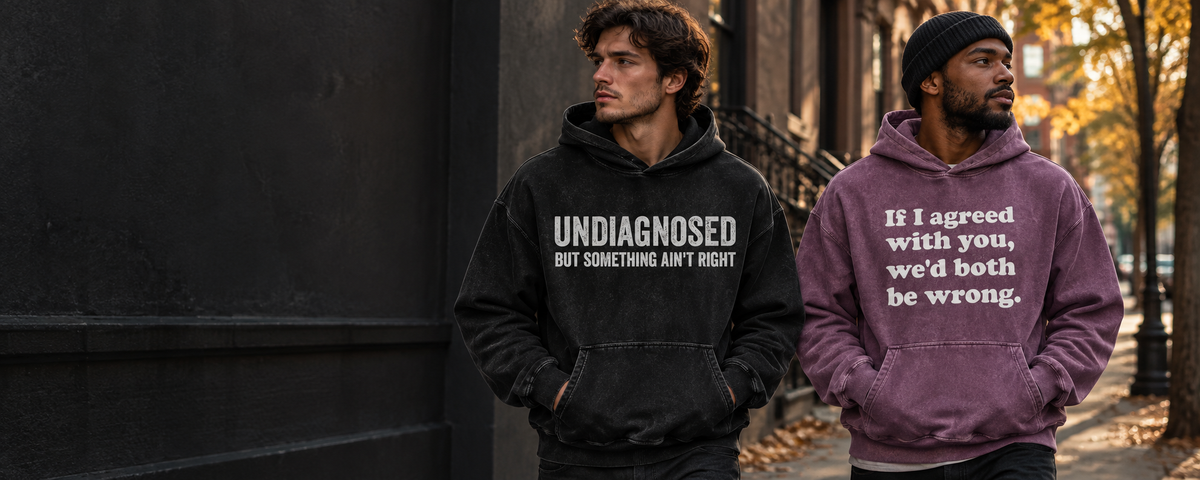 Two men wearing Regular Mess graphic hoodies on an autumn city street