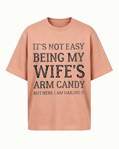 It's Not Easy Being My Wife's Arm Candy, but Here I Am Nailing It quote on Gray cotton T-shirt