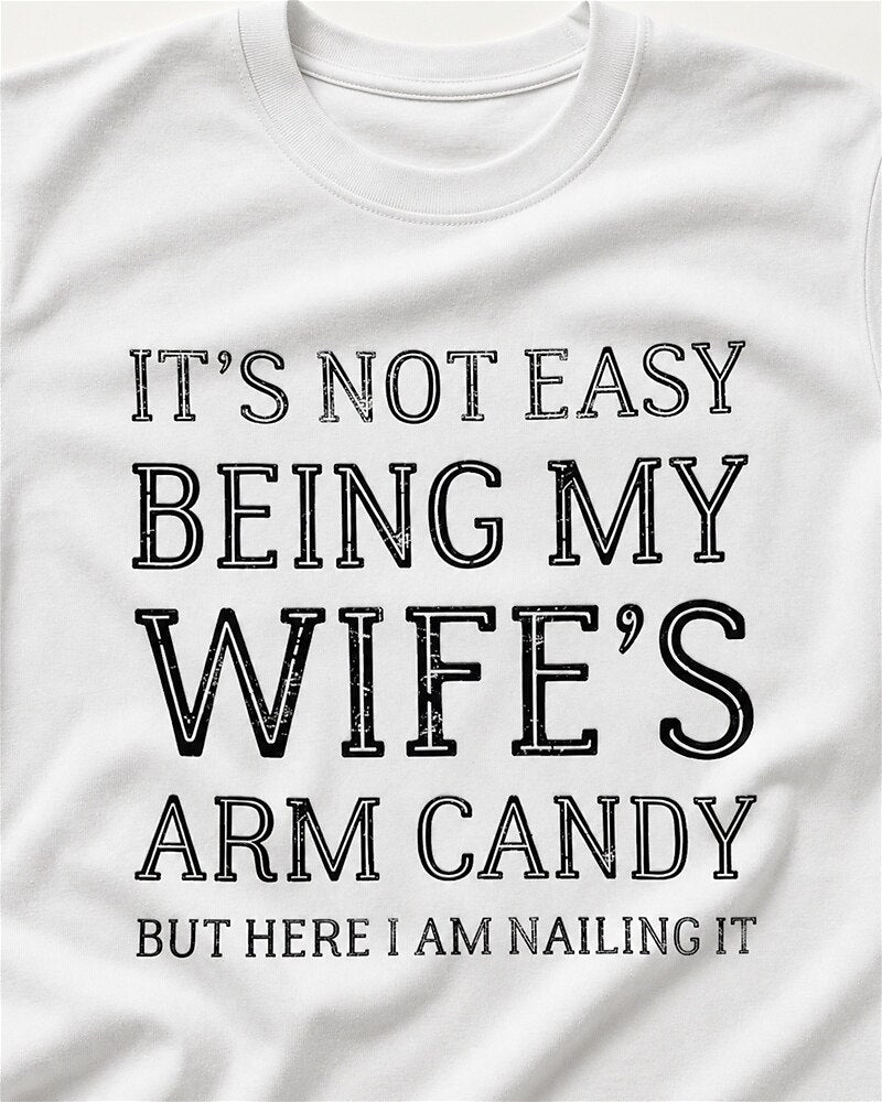 It's Not Easy Being My Wife's Arm Candy, but Here I Am Nailing It quote on Apricot cotton T-shirt