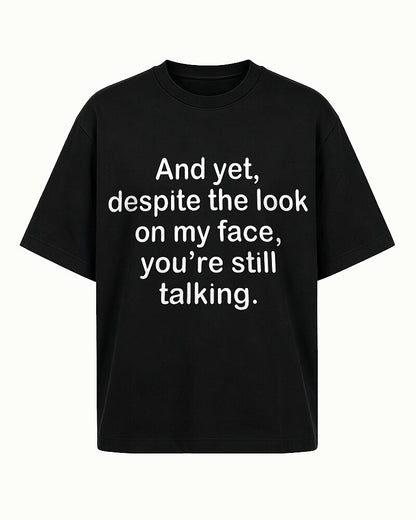 Despite the Look on My Face, You're Still Talking quote on Black cotton T-shirt